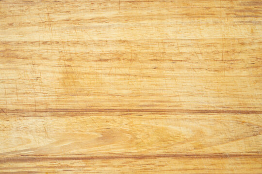 Used wooden kitchen cutting board background with trases of use cuts and spots. Perfect for culinary blogs