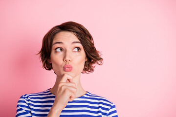 Portrait of young beautiful curious dreamy girl look copyspace pout lips hold hand chin dreaming isolated on pink color background