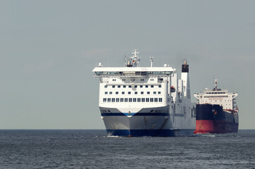 MARITIME TRANSPORT  - Passenger ferry and bulk carrier on waterway to the port 