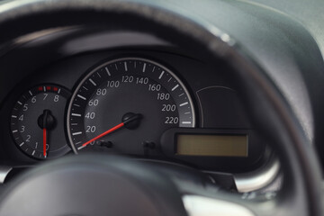Speedometer and tachometer on modern car dashboard