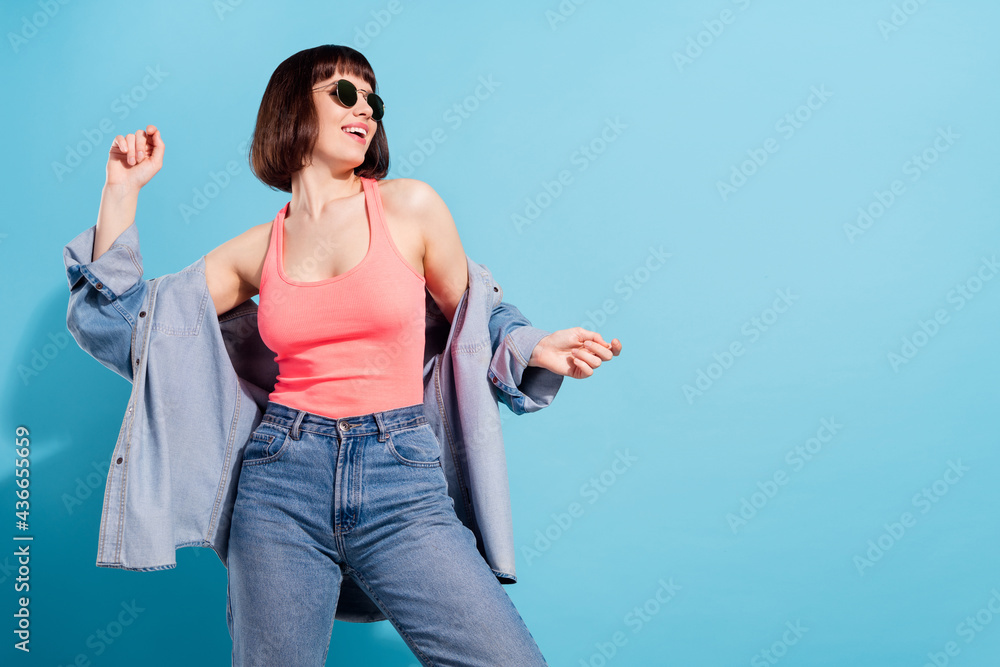 Poster Portrait of attractive cheerful girl dancing having fun copy space free time isolated over bright blue color background