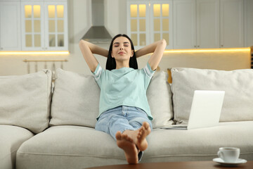 Young woman relaxing on sofa at home