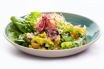 Vegetable salad in a blue plate 