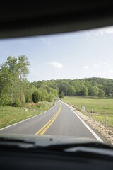 country road from inside vehicle during road trip travel