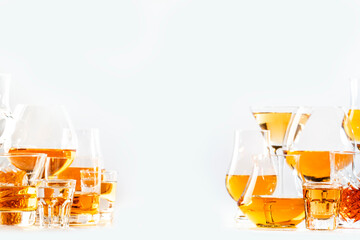 Hard strong alcoholic drinks, spirits and distillates in glasses in assortment: vodka, cognac,...