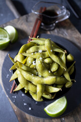 Coconut bowl with fresh edamames  ready to eat. Delicious edamames. Vegetarian and vegan food. Vegan protein