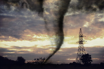 Dangerous whirlwind near transmission tower at field. Weather phenomenon
