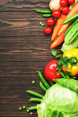 Healthy food. Assortment of fresh summer organic vegetables and herbs on wooden table background