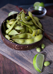 Coconut bowl with fresh edamames  ready to eat. Delicious edamames. Vegetarian and vegan food. Vegan protein