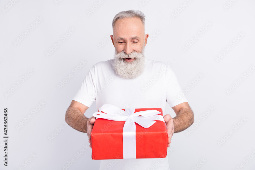 Sticker photo of positive happy attractive old grandfather receive present box birthday isolated on grey col