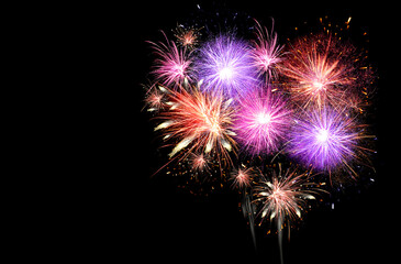 Beautiful bright fireworks lighting up night sky