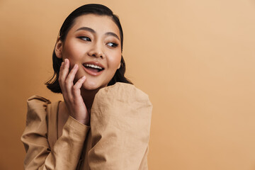 Young asian brunette woman posing and looking aside