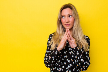 Young australian woman isolated making up plan in mind, setting up an idea.