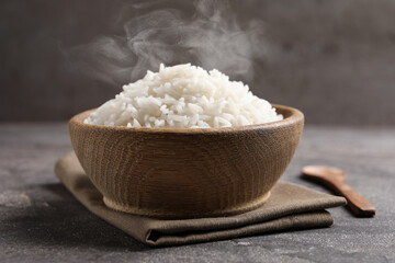 Bowl of tasty cooked rice served on table