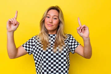 Young australian woman isolated indicates with both fore fingers up showing a blank space.