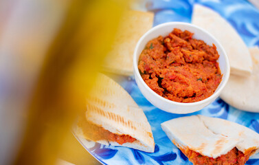 Red paste of dried tomatoes and peppers with pita - Mediterranean breakfast 
