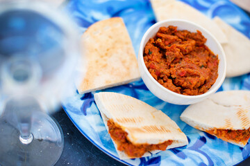 Red paste of dried tomatoes and peppers with pita - Mediterranean breakfast 