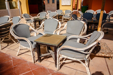 Fototapeta na wymiar Outdoor cafe in Hurghada, Egypt. Empty gray chairs. No visitors