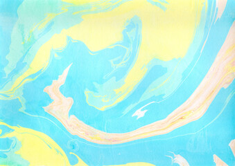青と黄色とピンクの水彩絵具で描いたマーブリング模様