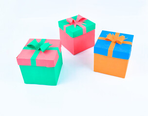 A line of three different colored hand made paper boxes with small decorative lids
