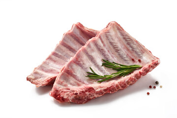 Raw Pork ribs with a rosemary and red pepper isolated on white background. Selective focus.