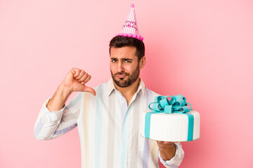 Young caucasian man celebrating his birthday isolated on pink background feels proud and self confident, example to follow.