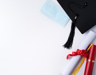 Graduation academic cap with diploma and mask isolated on white table background.