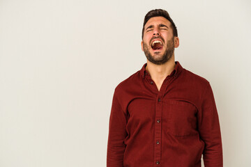 Young caucasian man isolated on white background shouting very angry, rage concept, frustrated.