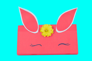 A pink colored hand made paper crafted pencil box placed on a isolated background