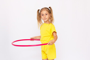 Little girl in a yellow dress is holding a hoop Isolated on white background.