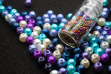 beads and bottles on a black background