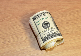 A bundle of one hundred dollar bills on table. Money account concept. US one hundred dollar bills background. Money american hundred and Financial operations concept