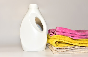 Detergent laundry bottle for washing clothes. Household for cleaning in laundry room. Detergents cliquid for washing machine. Housekeeping concept.