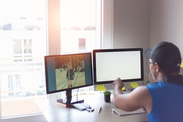 Latino man working in front of the computer with a photo of his daughter on the screen, work from home concept