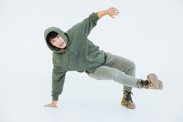 A man is performing a graceful dance in a white studio, performer masculine is a performance dancer, sportswear movement posing.