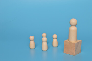 Wooden doll figures with their leader. Communication and social network