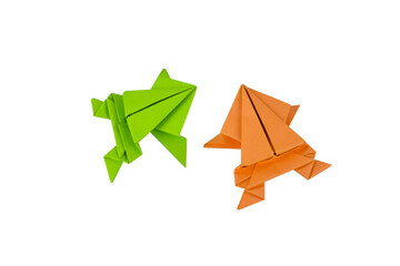 Couple of small hand made origami paper frog isolated on a clean paper background