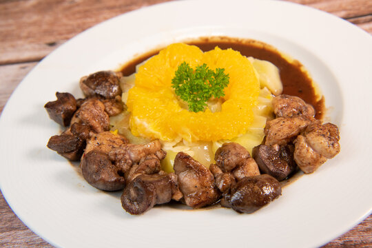 Recipe of sweetbread and lamb kidney with cocoa, leek whistles with almonds and oranges. High quality photo