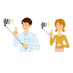 自撮り棒で撮影する男女