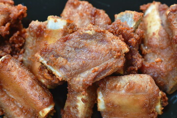 fried crispy pork bone or rib on plate dipping chili sauce cup