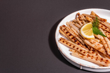 Grilled scorzonera with modern hard light, dark shadow