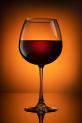 Still life, glass glasses with wine, on a background with a spot, and with a reflection