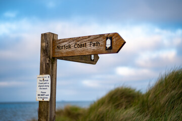 Close up of Norfolk Coastal Path sign at Cart Gap with shallow depth of field and bokeh
