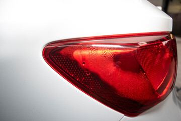 tail lights of a white car with condensation inside