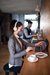 Business people with laptop working in cafe, small business, coronavirus and new normal concept.