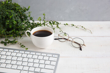 clean working desk with coffee and plant pot