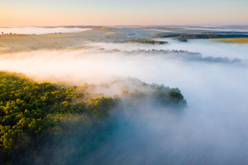 Awesome misty view of the countryside with the rays of morning light.