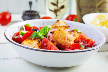 Traditional italian salad Tuscan Panzanella with tomato, bread and pickled olives