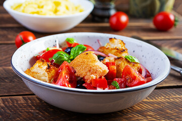Traditional italian salad Tuscan Panzanella with tomato, bread and pickled olives