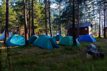 morning sunrise sunrise over a tented camp in a mountain gorge, travel romance and hiking camping